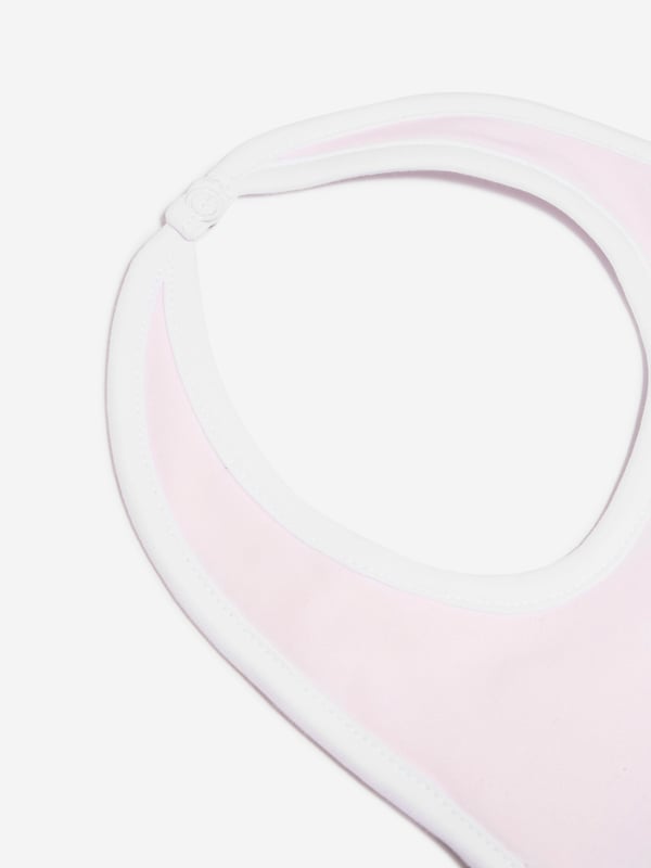 Introducing the luxurious Baby Girls Pima Cotton Bib in Pink by Magnolia Baby. An essential for your princess's nursery wardrobe! This high-end bib offers a blend of fashion and comfort. The key features are:  Chic Design: Features an adorable print in white, adding a stylish touch that transforms it into a statement accessory.  Premium Comfort: Meticulously crafted from superior Pima cotton, this bib delivers unparalleled softness for your baby's daily use.  Elevate your Baby_Girl's collection with the Magnolia Baby Bib in Pink. Your little one's feeding times now have an added dose of elegance! Order right away!