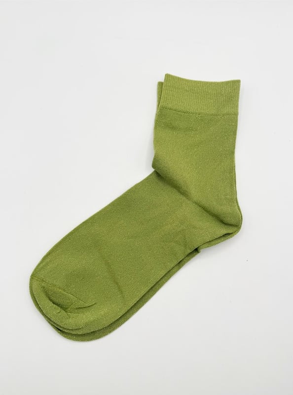 Green Glitter Socks by SVNX. Perfect for the gifting season! Treat yourself or someone special to this playful set of vibrant green glitter socks. With two pairs included, they're an easy way to add sparkle and fun to any outfit. Green Knitted Glitter Socks Set. One size. 2 pairs. Gift Box. Cotton/Polyamide/Elastane. Wash at 40. Made in China