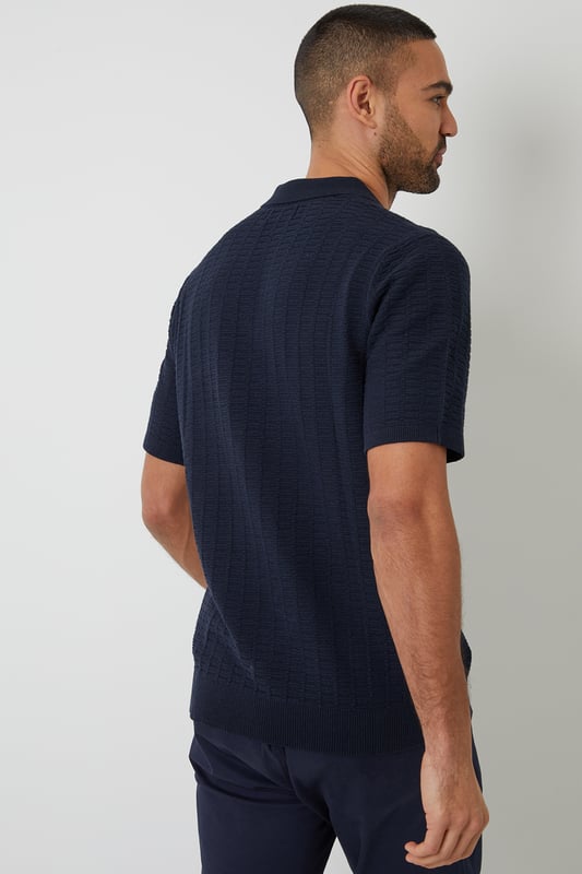 Add an easy-to-wear staple to your transitional wardrobe with this Threadbare button up knitted polo.
With an open collar fashioned with button up detail, this short sleeve knitted polo has small ribbed cuffs to the sleeve and a ribbed hem for comfort and ease.
In a textured stitch to the body to make it the perfect transitional piece for in-between weather, and finished with a metal branded tab above the hem.
Pair it with chinos or denim jeans and a smart coat for day-to-day wear that also works perfect for date night, or team with shorts for summer style.