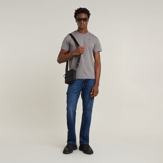 Zip fly. 5 pockets, incl. coin pocket caught in the seam. Tool loop at the side. G-Star RAW label at the back, made from a leather-like paper fabric. Zip & button closure. Mid waist. The Lenney jeans is designed in a straight fit that widens in a bootcut silhouette. The tool loop at the side adds interest. 100% Cotton. Rigid. Weight 11.3 oz. Bootcut