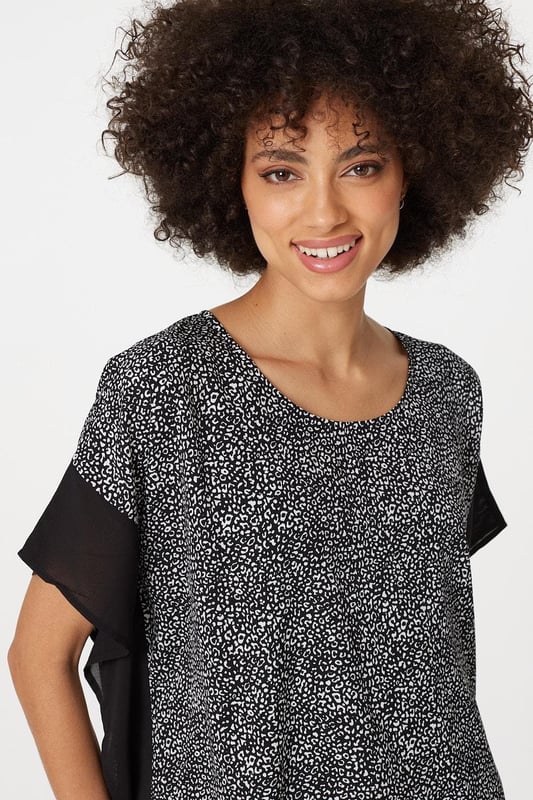 Make a statement with this leopard print poncho blouse top. It has a round neck, short sleeves, an oversized fit and a thigh length hem. Pair with fitted trousers and heeled wedges for a standout style that's perfect for date night or drinks with the girls.