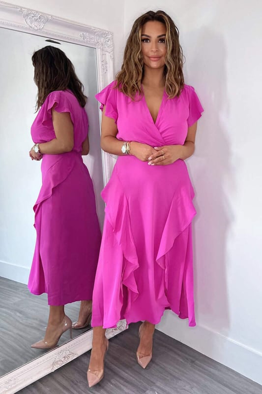 Our Cerise Frill Detail Double Split Skirt Midi Dress is right on trend this season! Featuring a v neck wrap top, short frill sleeves, a frill detail double split skirt and a zip up back.  Style with heels and a matching bag.   Model wears: UK 8/ EU 36/ US 4 Model's height: 165cm/ 5'5" Approx length from centre back to hem: 134cm Fabric composition: 100% Polyester Colour: CERISE