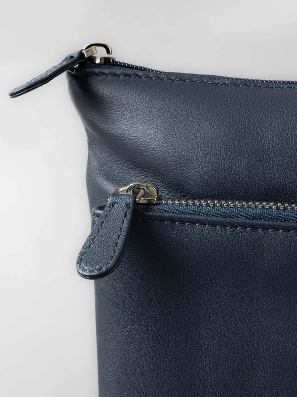 Welcome portable style into your handbag collection with the slimline yet pocket-packed Enderby cross body bag in easy-to-style navy.Crafted from soft and smooth leather, this bag features a large front zip and rear zip pocket on the outside for easy access valuables, and the interior boasts zip and slip pockets to ensure you stay organised on the go.The adjustable shoulder strap makes the Enderby ideal for everyday use, big enough for your essentials but superbly lightweight.The DetailsStyle: Enderby Leather Cross Body BagColour: NavyMaterial: LeatherDimensions: W22 x H24 x D2cmAdjustable leather strapAdjustable strap drop: Max 76cm - min 36cmZip top fastening with leather pullerLarge front zip pocketRear zip pocket And On The InsideOne zip pocketOne slip pocketFabric lining