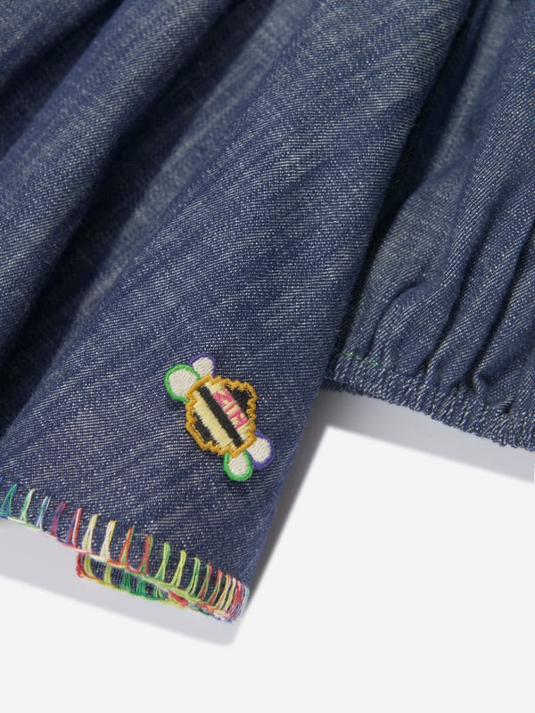 Australian label Zimmermann combine superior cutting with spellbinding silhouettes. This monsoon denim top is reflective of the brand's commitment to originality and high quality detailing. Crafted with a multi-hued embroidered trim, it features a square collar, a flounced trim on the shoulders and puff sleeves. It is complete with a small embroidered bee logo above the hem. Matching shorts are also available. Pure Cotton Button Fastening on Reverse 100% Cotton