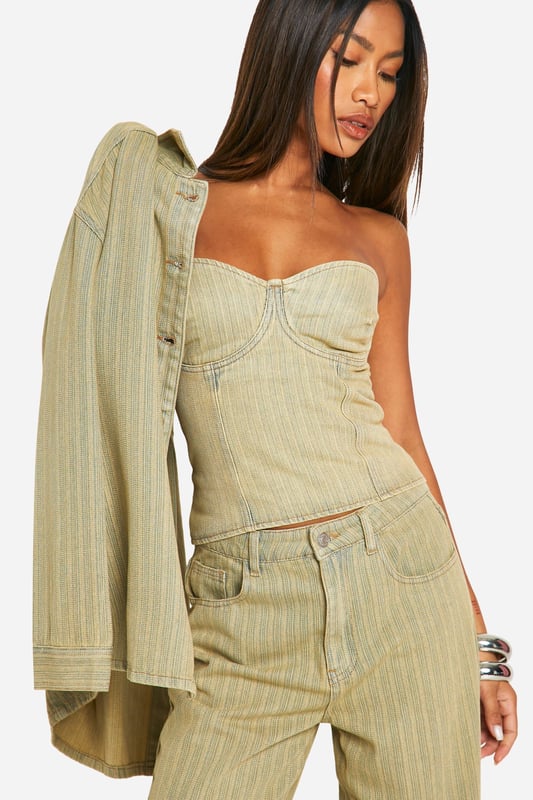 Strapless denim corset top with structured bustier design
        Flattering sweetheart neckline for a feminine silhouette
        Vertical seam detailing for a figure-enhancing effect
        Versatile toned denim fabric for day-to-night styling
        Pairs perfectly with matching wide-leg trousers for a coordinated look
    
    Make a bold statement with this eye-catching denim corset top from Boohoo. The structured bustier design and sweetheart neckline create a flattering silhouette that's sure to turn heads. Perfect for a night out on the town, this versatile piece can be dressed up or down to suit any occasion. Pair it with the matching wide-leg trousers and an oversized blazer for a chic, coordinated ensemble that's ideal for drinks with friends or dancing the night away. For a more casual look, team it with high-waisted jeans and trainers. The toned denim fabric adds a contemporary twist to the classic corset style, making it a must-have addition to your wardrobe. Whether you're hitting the club or meeting for cocktails, this corset top will ensure you stand out from the crowd.