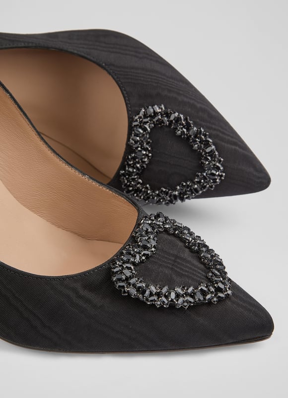 The Luella heart crystal court, in stunning black moirÃ© fabric, features a pointed toe and a sleek stiletto heel, all lined with luxurious leather. Pair these Spanish-made shoes with a stylish cocktail dress or enhance your favourite skinny jeans.
