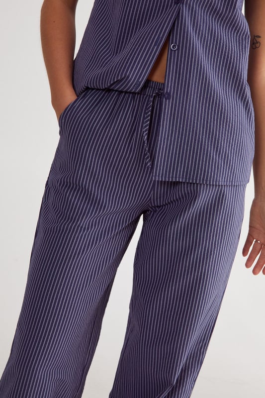 Straight leg design for a classic silhouette
        Vertical stripe pattern adds visual interest
        High-waisted fit for a flattering look
        Side pockets for practicality
        Coordinating sleeveless top with unique front opening
    
    Make a statement with these eye-catching stripe straight leg trousers from NastyGal. The vertical stripe pattern elongates your figure, while the high-waisted design accentuates your curves. Pair with the matching sleeveless top for a coordinated ensemble that's perfect for casual outings or family gatherings. The straight leg cut offers versatility, allowing you to style with trainers for a laid-back look or dress up with heels for a more polished appearance. The side pockets add functionality to this fashionable piece. For a trendy twist, layer with a cropped jacket or oversized blazer. These trousers are a wardrobe essential that can be dressed up or down, making them ideal for various casual occasions throughout the year.