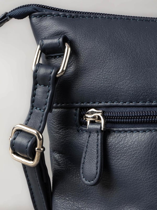 Welcome portable style into your handbag collection with the slimline yet pocket-packed Enderby cross body bag in easy-to-style navy.Crafted from soft and smooth leather, this bag features a large front zip and rear zip pocket on the outside for easy access valuables, and the interior boasts zip and slip pockets to ensure you stay organised on the go.The adjustable shoulder strap makes the Enderby ideal for everyday use, big enough for your essentials but superbly lightweight.The DetailsStyle: Enderby Leather Cross Body BagColour: NavyMaterial: LeatherDimensions: W22 x H24 x D2cmAdjustable leather strapAdjustable strap drop: Max 76cm - min 36cmZip top fastening with leather pullerLarge front zip pocketRear zip pocket And On The InsideOne zip pocketOne slip pocketFabric lining