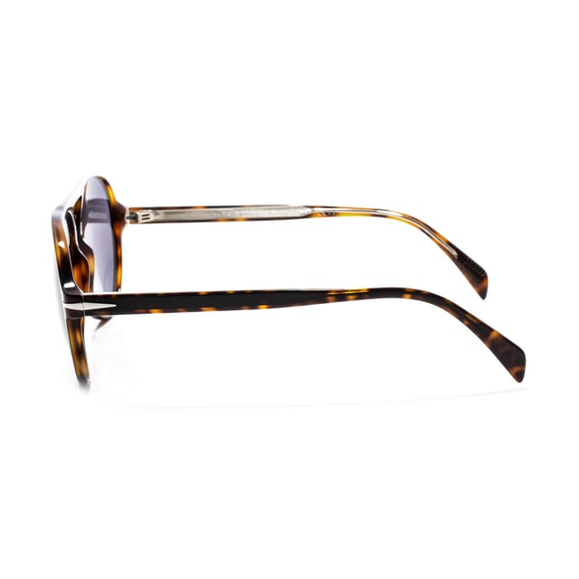 7005S sunglasses with acetate frame.

 Shape and design:
 - These David Beckham glasses have an aviator silhouette.

 Frame material:
 - The frame of these glasses is made of acetate, a plastic material.
 - Acetate provides durability, flexibility and a smooth finish to the frame.

 Acetate temples:
 - The temples are also made of acetate, matching the frame material.
 - The acetate in the temples makes them light and comfortable to wear.

 Brand details:
 - DB brand engraving on the lens.
 - These design elements help to clearly identify the model as part of the David Beckham eyewear collection.

 Glasses:
 - The lenses are of high quality.
 - These lenses provide excellent UV protection and sharp, clear vision.
 Measures: Lens height: 52 mm. Lens width: 57 mm. Bridge: 17 mm. Temples: 145 mm.
 Composition: Acetate
 Care:
Use a soft, clean microfiber cloth to clean your sunglasses. This type of cloth will not scratch the lenses.
 Avoid using abrasive cleaning products, detergents, alcohol or acetone, as they can damage lenses and anti-reflective treatments.