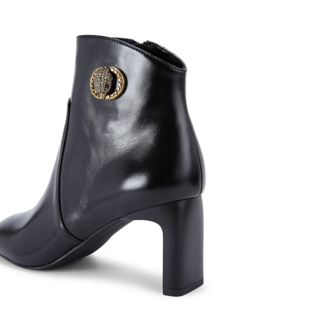 This Kurt Geiger Chelsea Square Toe Bootie is crafted from a black leather. There is an antiqued brass buckle with eagle head that is embellished with crystals sat on the outer side of the ankle. Heel height: 7.5cm.