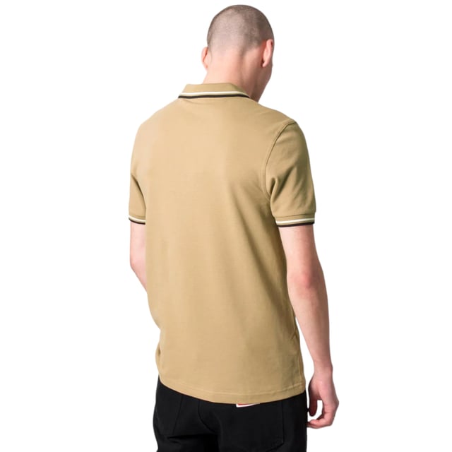 The Twin Tipped Fred Perry Polo Shirt by Fred Perry is a short sleeved polo shirt that has been made from Fred Perry's classic cotton piqué, in a contemporary adaptation of Fred's famous streamlined fit. Available in a diverse range of colourways - each with their own unique story. Featuring the signature Fred Perry wreath logo to the chest and twin tipping to the collar and cuffs.