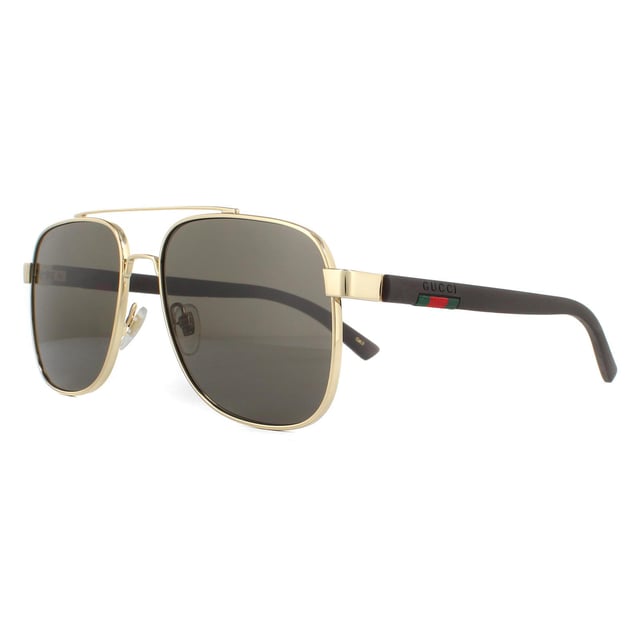 Gucci Sunglasses GG0422S 003 Gold Brownare a sophisticated square aviator design. The metal frame front features a double bridge and adjustable nose pads for a comfy fit. Rubberised temples showcase the brand's text logo as well as their signature green and red stripe..