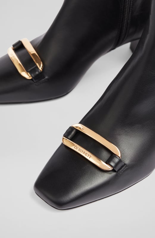 LK Bennett Novella Ankle Boots,Black A chic leather ankle boot with a bit of detail, our new Novella boots can elevate the everyday when you need them too. Crafted in Spain from beautiful black smooth calf leather, they have an almond-shaped toe, a gold bar embellishment with LKB logo detail, an inside zip and a leather-wrapped 60mm block heel. Wear them with tailoring, dresses or jeans - Novella can do it all.