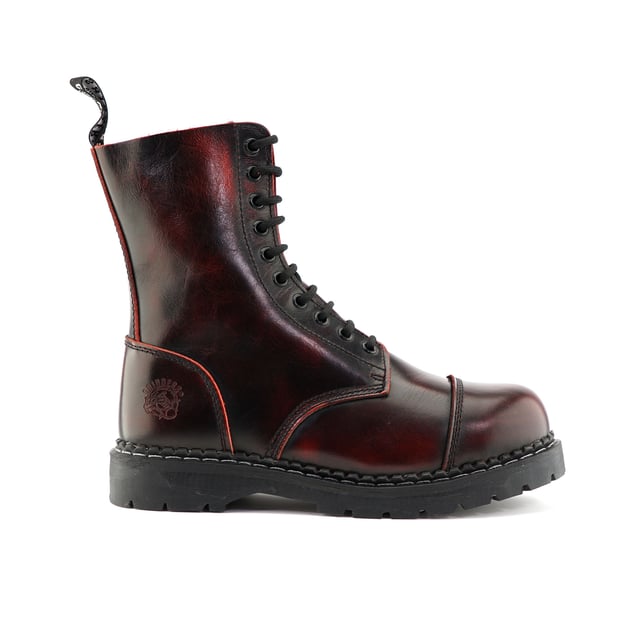 The Stag ACS, a celebrated staple of Grinders' original lineup, has maintained its status as a best seller with its 2015 update. This updated model features a 10-eyelet lace system for a secure fit and is reinforced with a steel toe cap certified to EN ISO 20345:2011 SB standards for enhanced safety. The boot's padded insole provides added comfort, while its durability is assured by a chunky, oil-resistant rubber sole that is Goodyear welted for long-lasting wear. Additionally, the Stag incorporates Grinders' Air Cushioned Soles (ACS) for superior comfort. A branded pull loop at the boot's opening ensures ease of wear and removal. 10 Eyelet Derby Boot, Steel Toe (Certified EN ISO 20345:2011 SB), Goodyear Welted, Grinders’ Air Cushioned Soles (ACS), Leather Uppers
