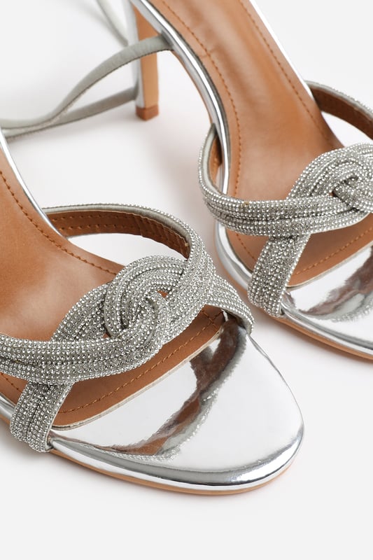 Introduce a touch of glamour to your footwear collection with our Adana Diamante Knot Detail with Cross Over Ankle Strap High Heels. These heels are the epitome of elegance and sophistication, making them the perfect finishing touch to any outfit, whether it's for a formal event, a night out, or a special occasion.

Key Features:



Exquisite Design: Enhanced by the diamante knot detail, these shoes are guaranteed to make heads turn.

Cross Over Ankle Strap: The cross-over ankle strap doesn't just lend a chic and trendy vibe, but also offers secure and comfortable fastening. Adjust the strap for a custom fit, ensuring these heels stay firmly in place.

High-Quality Construction: Crafted from premium materials, these high heels are designed to last. The high-quality construction ensures long-lasting durability while maintaining the comfort of your feet.


Specifications:


Material: Faux Leather
Closure: Ankle strap with buckle
Heel Height: 3.3' (8.3cm) approx

Invest in our Adana Diamante Knot Detail with Cross Over Ankle Strap High Heels and bring that extra touch of elegance and sophistication to your wardrobe. They speak loud and clear of luxury and style – a piece worth showcasing!