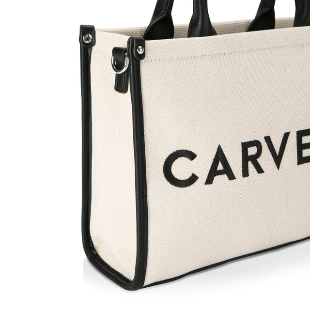 The Carvela Sorrento Tote bag features a beige fabric exterior with structure. There are black trims and branding on the front. 23cm (H), 30cm (L), 10cm (D). Strap length: 122cm.