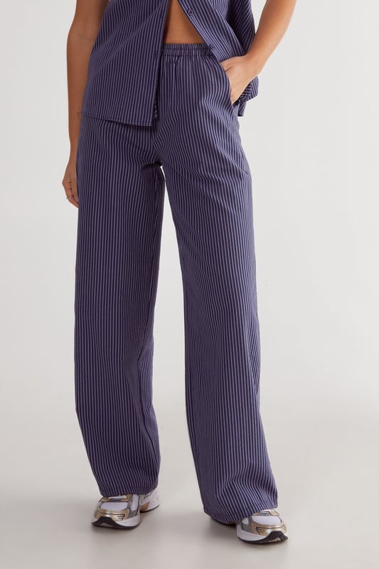 Straight leg design for a classic silhouette
        Vertical stripe pattern adds visual interest
        High-waisted fit for a flattering look
        Side pockets for practicality
        Coordinating sleeveless top with unique front opening
    
    Make a statement with these eye-catching stripe straight leg trousers from NastyGal. The vertical stripe pattern elongates your figure, while the high-waisted design accentuates your curves. Pair with the matching sleeveless top for a coordinated ensemble that's perfect for casual outings or family gatherings. The straight leg cut offers versatility, allowing you to style with trainers for a laid-back look or dress up with heels for a more polished appearance. The side pockets add functionality to this fashionable piece. For a trendy twist, layer with a cropped jacket or oversized blazer. These trousers are a wardrobe essential that can be dressed up or down, making them ideal for various casual occasions throughout the year.