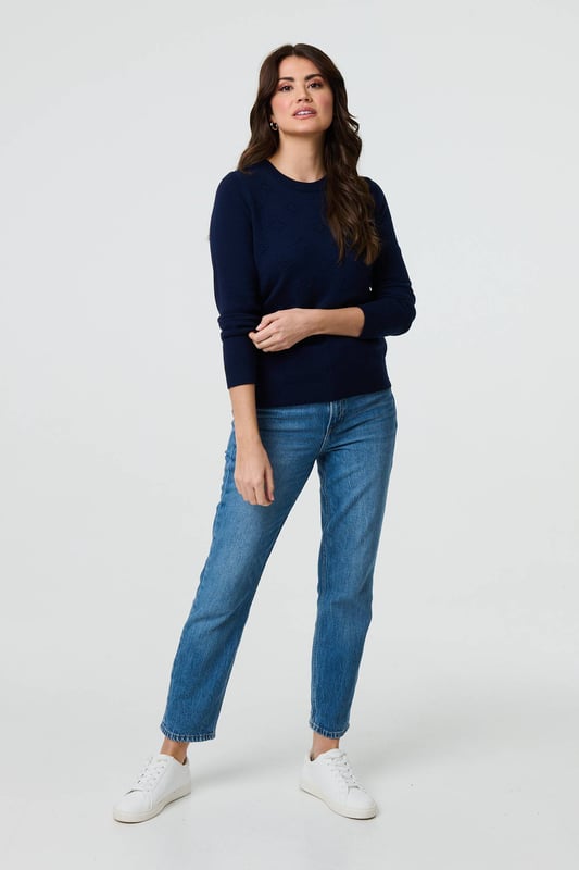 Get a classic look in this slim jumper. It has an embroidered texture on the front, long sleeves and a flattering hip length hem. For an effortless professional outfit, pair with a midi skirt or fitted trousers. This top is also made from a breathable viscose blend.