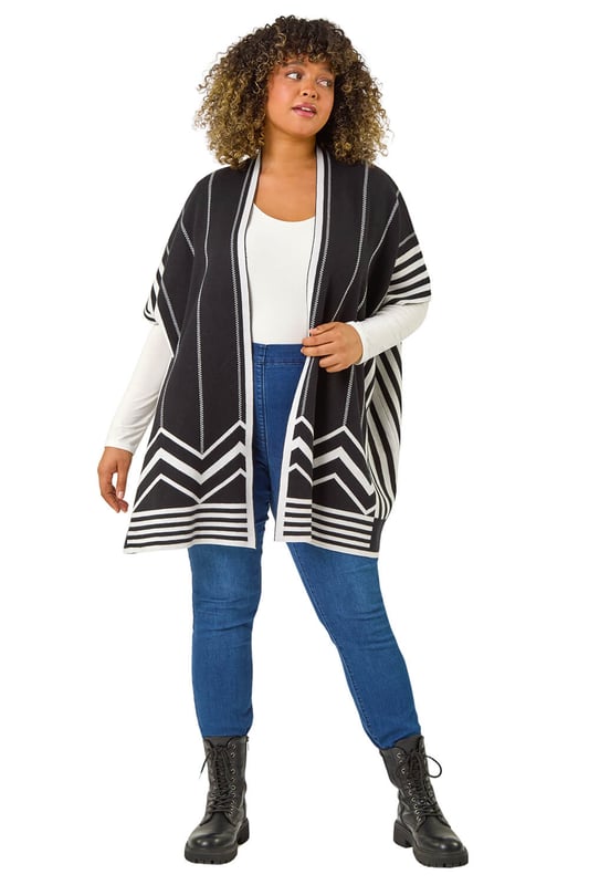 Curve Stripe Hem Square Poncho from Roman. Wrap up in style this Autumn with this our Curve stripe print poncho. Featuring an edge to edge opening and a beautiful border print detail, this versatile cardigan is perfect for adding a touch of sophistication to any outfit. Cut from a soft knit fabric finishing below hip length with trendy 3/4 sleeves, this square-shaped poncho is both cosy and stylish. Simply layer over a classic t-shirt and jeans for a casual yet put-together look!