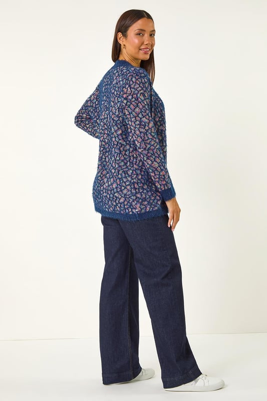 Mosiac Fluffy Trim Cardigan from Roman. Stay stylishly warm this Winter with our mosaic fluffy cardigan. This cosy piece features a unique mosaic design with a contrasting placket and cuff details, adding a touch of interest to your look. The long sleeves and secure edge to edge front provide extra warmth, while the longline length gives a flattering silhouette. Pair with a simple t-shirt and jeans for an effortlessly chic and cosy outfit.