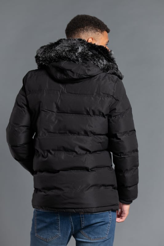 This longline hooded padded jacket from Nines by Kensington Eastside will ensure you are kept warm on colder days. Features faux fur hood with toggles and inside fur lining, zip and popper fastening, two large zip fastening pockets with divider, and ribbed elasticated cuffs for extra comfort.