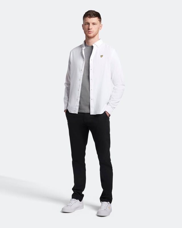 Crafted from 100% cotton from unrivalled softness, the Lyle & Scott Plain T-Shirt is an iconic style and the definition of a wardrobe staple. Featuring a classic silhouette, detail stitching at collar and cuff, plus our signature Golden Eagle, this t-shirt can be seamlessly layered or stand alone as the centrepiece of any smart-casual outfit.  
  
Fit: Regular
It is crafted to fit the body neither too tightly or too loosely, leaving you with a classic, timelessly stylish look. We recommend you order your usual size, but if you're caught between two, go a size up.