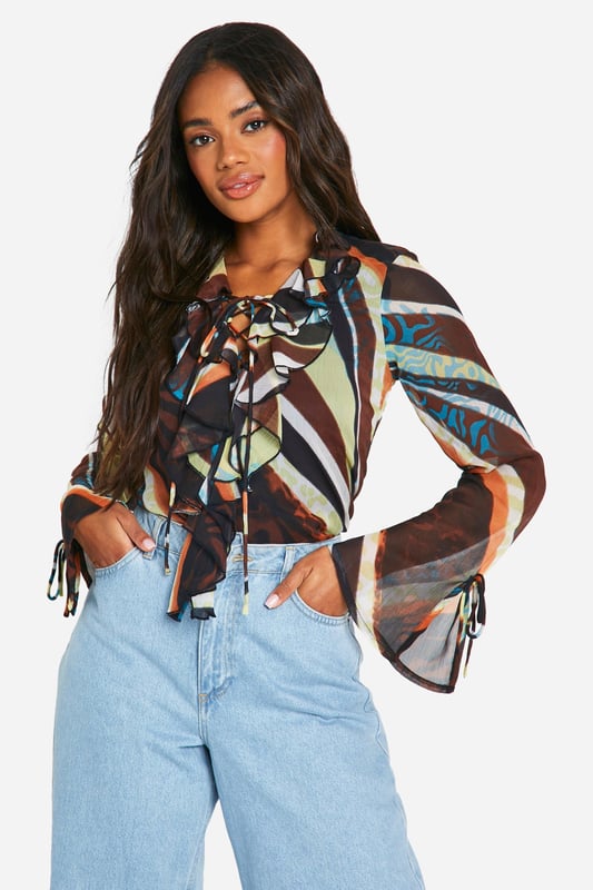 This season, we're turning up the heat - and turning heads, so this going out top is an absolute wardrobe staple. Create outfit after outfit in all kinds of styles; a party top teamed with a cute pair of jeans or trousers is always perfect for that lowkey going out look. From sequin tops to satin styles, evening tops always make an impression when thrown together with a chic skirt or shorts. If there's one thing this stylish top is, it's statement-making.Style: BlouseDesign: AbstractFabric: ChiffonLength: RegularNeckline: V NeckSleeve Length: Long Sleeve