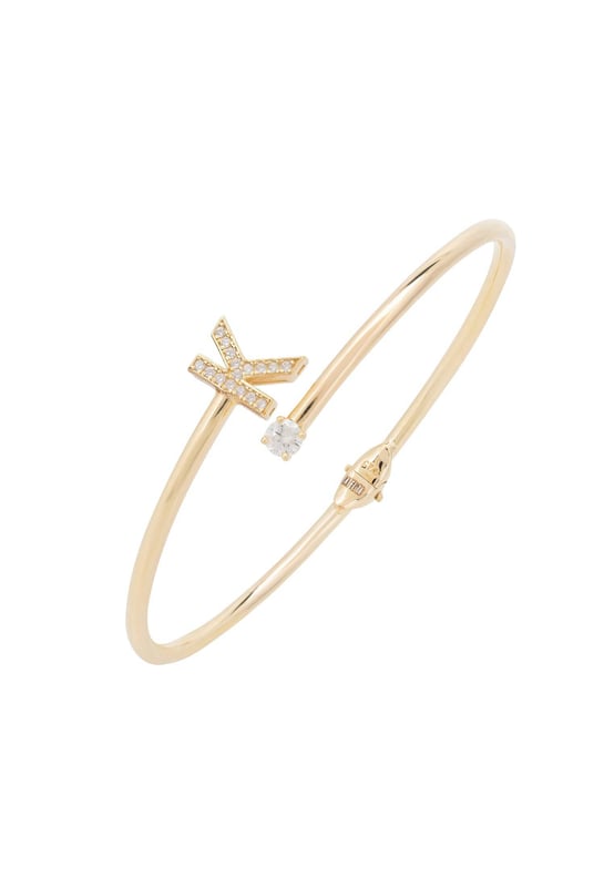 Design:This simple but beautifully styled initial bangle bracelet is perfect for those who covet delicate jewellery with a hint of sparkle, offering a sophisticated finishing touch to any outfit.Pretty and petite, this initial open cuff bangle features a hinge on the underside which makes it easy to put on and take off. The opening is designed to be on top of the wrist, where a zircon adorned monogram sits on one side and a single larger cubic zirconia resides on the other.What can be more personal than a name? Give this initial bangle bracelet as the perfect personalised birthday gift. Materials:Handcrafted using 925 sterling silver, dipped in 22ct gold. White cubic zirconia.Style Notes:Perfect pairing to the initial ring.Personalised birthday gift ideas. Bridesmaid gifts. Simple everyday styling.Dimensions:Bracelet: 19.5cm Packaging:This item is presented in a Latelita London signature jewellery box.Care Instructions:To maintain your jewellery, wipe gently with a damp cloth that is soft and clean. Do not soak in water. Avoid contact with soaps, detergents, perfume or hair spray.
