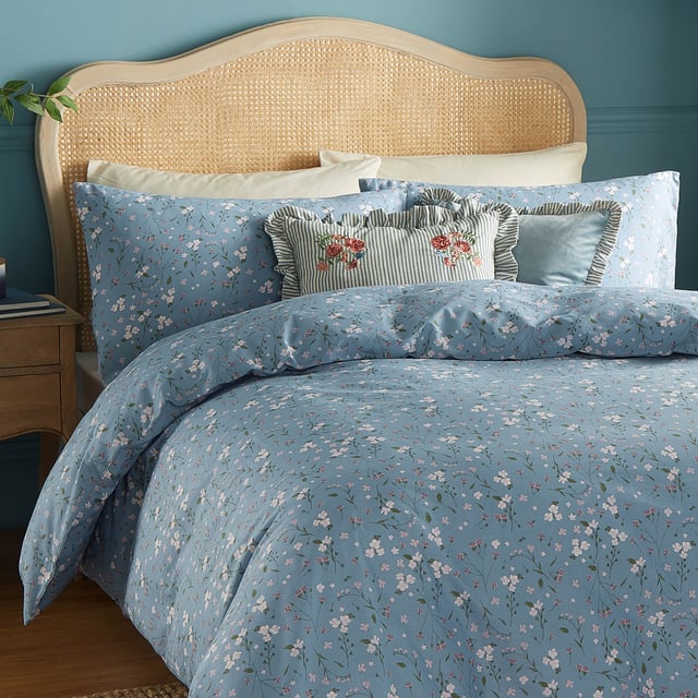Transform your bedroom into a serene retreat with the Bronte Floral Duvet Cover Set. Crafted from 100% cotton and featuring a 144-thread count, this duvet cover combines comfort with timeless elegance. The classic English garden ditsy print showcases delicate lilac forget-me-nots and subtle foliage, offering a refined touch that speaks to lovers of nature and understated beauty. The same exquisite design graces both sides, allowing it to stand alone as a statement piece. With Bronte, experience the perfect blend of sophistication and natural allure that invites tranquillity and style into your living space. 200 x 200cm