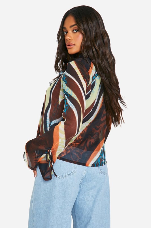 This season, we're turning up the heat - and turning heads, so this going out top is an absolute wardrobe staple. Create outfit after outfit in all kinds of styles; a party top teamed with a cute pair of jeans or trousers is always perfect for that lowkey going out look. From sequin tops to satin styles, evening tops always make an impression when thrown together with a chic skirt or shorts. If there's one thing this stylish top is, it's statement-making.Style: BlouseDesign: AbstractFabric: ChiffonLength: RegularNeckline: V NeckSleeve Length: Long Sleeve