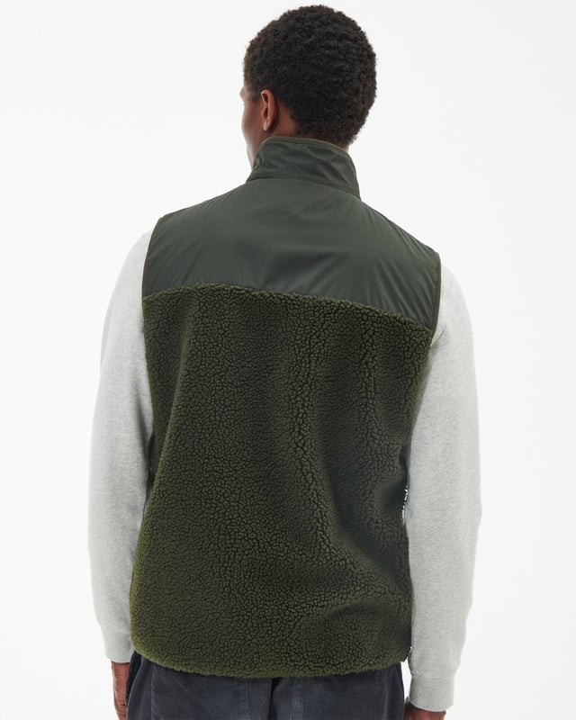 Barbour Newlan Fleece Gilet
A layering essential for the cooler months of the year, the Barbour Newlan Fleece Gilet is made from soft faux fur for a cosy look and feel. Boasting contrast panelling to the upper yoke and collar, it comes with lower welt pockets and tonal lycra binding to keep out the chill.

Barbour embroidery to left pocket
Main fabric (faux fur): 100% polyester
Secondary fabric: 100% polyester
Filling: 100% polyester
Machine wash 30?C
Back length: 70.5cm - 76.5cm

MFL0171