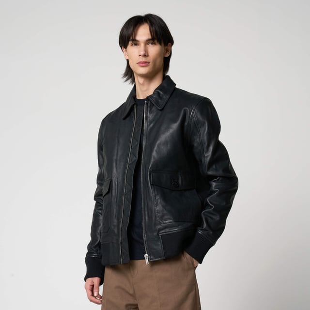Men’s Barneys Originals goat leather bomber jacket. Features classic patch pockets, a Harrington-style collar, and knit rib detailing on the cuffs and hem for a timeless, structured fit.