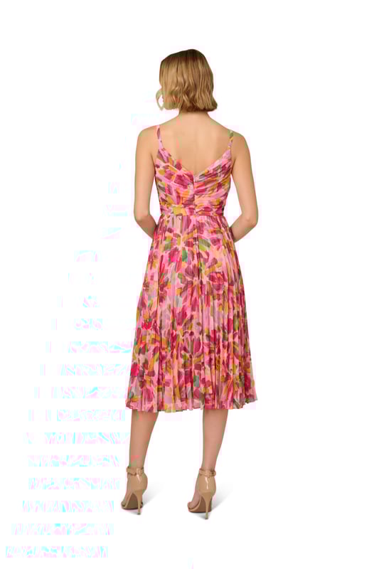 Romantic design details flourish throughout this midi dress. This dress features a shirred bodice with tank straps, v-neckline, and pleated soft skirt. Crafted from lightweight chiffon that is covered in a bright, abstract floral print, this dress has limited stretch and a waist seam. A scoop back and hidden zipper closure completes this midi dress. Pair this dress for day with a simple sandal or dress it up for a cocktail attire event with metallic heels and sparkling accessories.