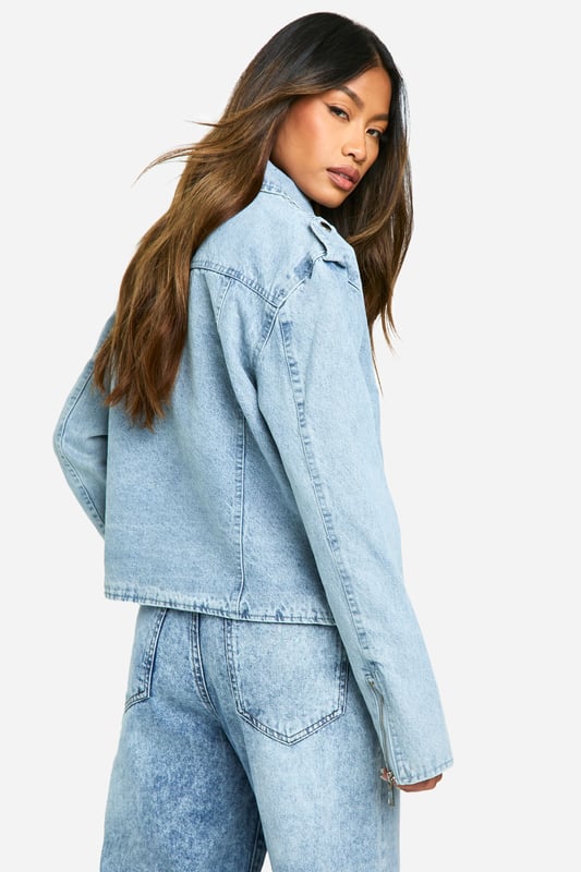 Classic biker-style denim jacket with a modern twist
        Adjustable belt detail for a customisable fit
        Asymmetrical zip closure for edgy appeal
        Notched collar and epaulettes for authentic biker look
        Functional side pockets and chest pocket for practicality
    
    Embrace your inner rebel with this contemporary take on the timeless denim jacket. The biker-inspired design combines urban edge with versatile style, making it a must-have addition to your wardrobe. Perfect for casual outings, this jacket can effortlessly transition from day to night. Pair it with high-waisted jeans and a graphic tee for a laid-back lunch date, or throw it over a floral dress to add a touch of attitude to your ensemble. The adjustable belt allows you to cinch in the waist for a more tailored silhouette or leave it loose for a relaxed vibe. Ideal for family gatherings or casual meet-ups with friends, this jacket is sure to become your go-to outerwear piece. Its durable denim construction ensures longevity, while the classic design promises to remain stylish season after season.