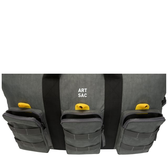 The ultimate carry companion, perfect for every day wear. Featuring a full-length zip top opening and 3 large side pockets, the Haring Triple Holdall is spacious enough for any short or long trip away. Features a detatchable shoulder strap. Features: , Water Resistant, 15 inch padded laptop sleeve - Fits Apple MacBook Pro 16 inch, Grab handle carry straps, Removable shoulder strap allowing crossbody styling, Zip top opening to main compartment, Triple front zip pocket with webbing loops Single zip pocket for smaller valuables, Internal zip pocket, 2 Internal mobile phone slip pockets - Fits normal and plus size smart phones, 3 Internal pen slip pockets, External rear zip pocket Style Ref: 52004 GREY