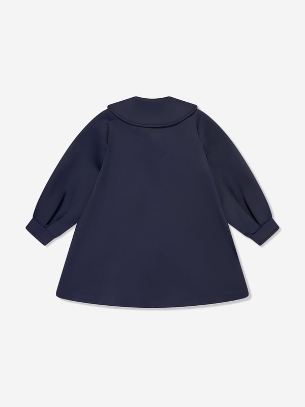 Mama Luma incorporate beautiful eco-friendly materials into their sophisticated handmade constructions. This girls navy long coat is reflective of the Californian label's precision of beauty. It showcases a Peter Pan collar, tie-up bow and balloon sleeves.  Cuffs Cotton Lining