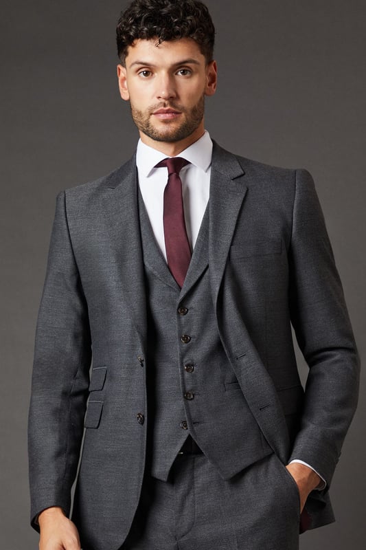 Slim fit design for a modern, tailored silhouette
        Tweed-look fabric adds texture and sophistication
        Notched lapels and two-button closure for classic styling
        Flap pockets and chest welt pocket for practicality and style
        Versatile charcoal hue suitable for various occasions
    
    This Burton slim fit suit jacket presents a refined option for the discerning gentleman. The tweed-look fabric lends a touch of traditional charm to a contemporary silhouette, making it an ideal choice for the modern man who appreciates classic style. Perfect for smart casual events or more formal occasions, this jacket can be styled with matching trousers and a waistcoat for a complete suited look. For a sophisticated ensemble, pair with a crisp white shirt and a deep burgundy tie as shown. Alternatively, dress it down with a light blue Oxford shirt and dark denim for a smart pub outing with mates. The versatile charcoal hue ensures this jacket will become a staple in your wardrobe, easily transitioning from office to evening wear. Whether you're heading to a business meeting or a weekend wedding, this Burton suit jacket will have you looking sharp and feeling confident.