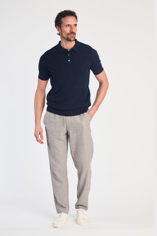 This textured polo shirt from Nines Collection blends classic sophistication with modern design. Crafted from a premium cable fabric with a subtle pattern, it offers a refined yet contemporary look. Lightweight and breathable, it’s a versatile choice for smart-casual occasions, ensuring style and comfort effortlessly. Made from 100% Cotton.