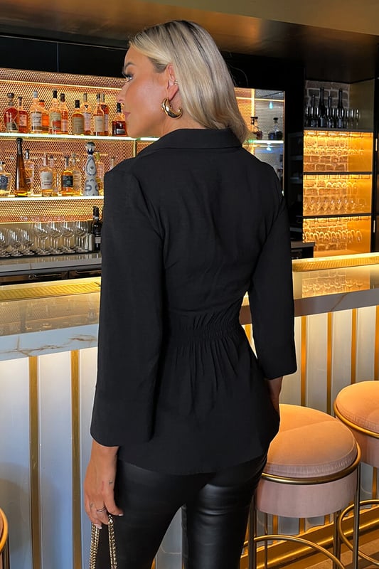 Our Black 3/4 Sleeves Collared Gathered Waist Top is a wardrobe
essential for this season. Featuring a classic shirt collar, a gold
button up front, 3/4 sleeves and a gathered side detail waist with an
elasticated back. Dress it up with leather pants and heels or dress it
down with jeans and some boots.

Model wears: UK 8/ EU 36/ US 4
Model's height: 175cm/ 5'9"
Approx length from centre back to hem: 72cm
Fabric composition: 100% Polyester
Colour: BLACK