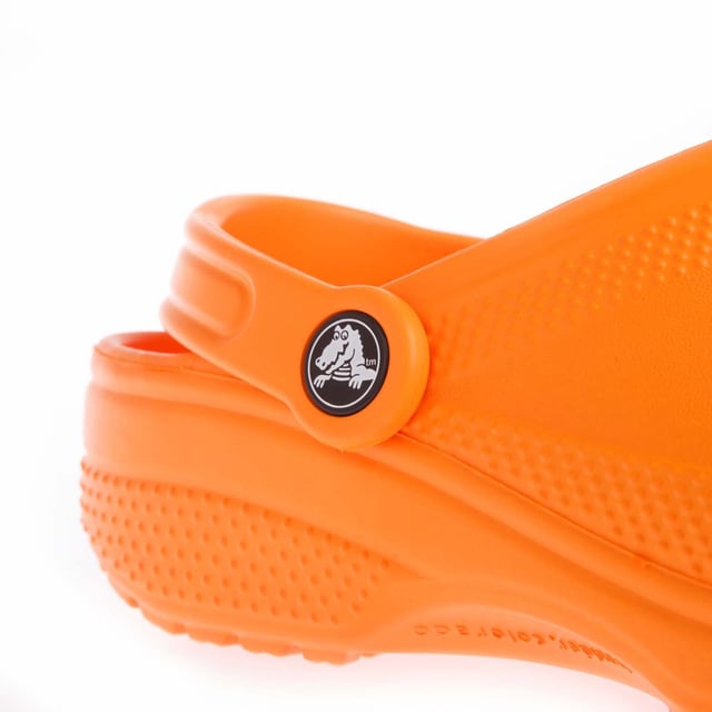 Juniors Crocs Classic Clogs in orange.- Slip on fastening.- Ventilation ports add breathability and help water and debris drain away.- Heel strap.- Fully molded Croslite™ material for signature Crocs comfort.- Lightweight  non-marking soles.- Ref: 20699183A