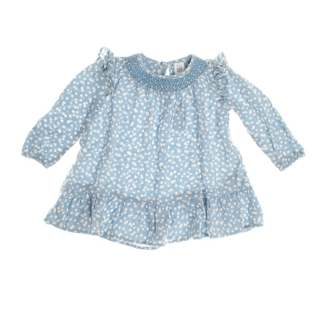 Baby dress with delicate details that enhance her charming style.

 The gathered collar gives it a special touch, and the long sleeves with ruffles on the shoulders add a romantic air.

 The skirt features a soft flare with a ruffle at the hem, adding movement and grace to the design.

 A perfect garment to combine comfort and elegance, ideal for both everyday and special occasions.
 Composition: 100% Viscose
 Care:
- Machine wash max. 30ºC.
 - Use similar colors in the wash.
 - Avoid the use of bleaches.
 - Dry at low temperature.
 - Iron at low temperature.
 - Do not dry clean.
