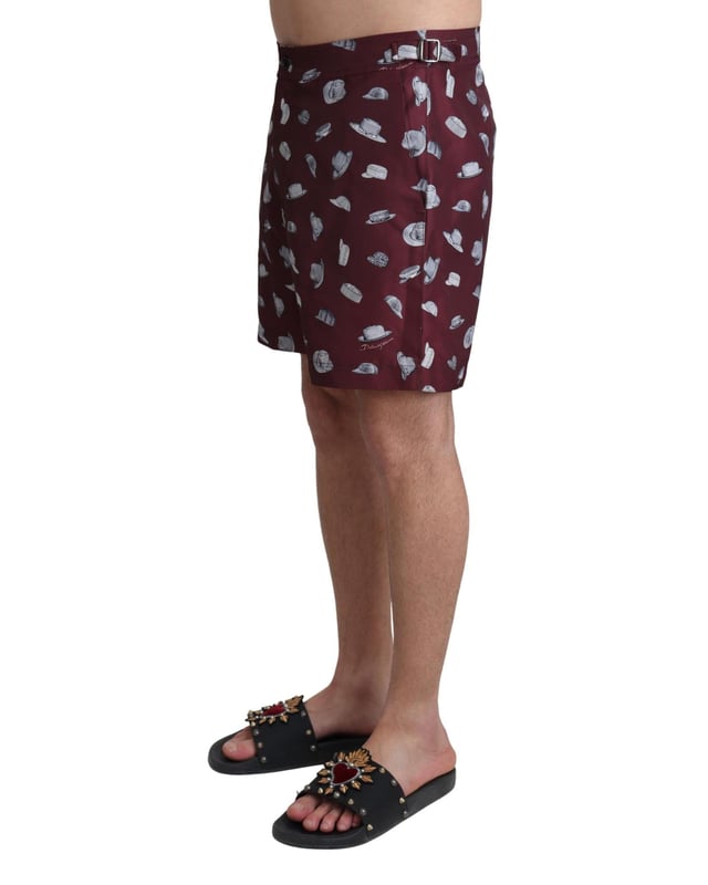 Absolutely stunning 100% Authentic exclusive brand new with tags
  Dolce &amp; Gabbana Beachwear swimming trunks
  2 inset front pockets
  1 zip rear pocket with hats print
  Modell: Swimshorts Trunks Boxer
  Color: Maroon
  Material: 100% Polyester
  Elastic waist strap
  Two front pockets and one back pocket
  Logo details
  Great fitting and comfort
Material: 100% Polyester