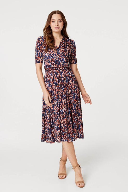 Add a comfortable jersey dress to your wardrobe with this printed midi. It has a v-neck with a faux wrap front, 1/2 sleeves, a flattering ruched waist and a straight midi length skirt. Pair with heels or boots for a go-to style to wear during transitional seasons.