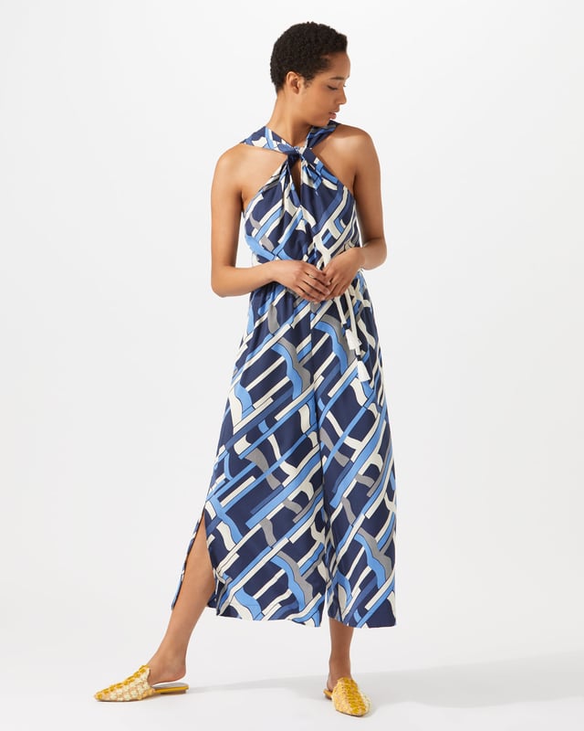 This jumpsuit features an exclusive modern Jigsaw print, hand-drawn by our in-house artist as a modern take on a check. Styled with a wide leg, it has a twist design at the neck and a rope tie at waist for a playful finish. Pair with heels for summer evenings out.