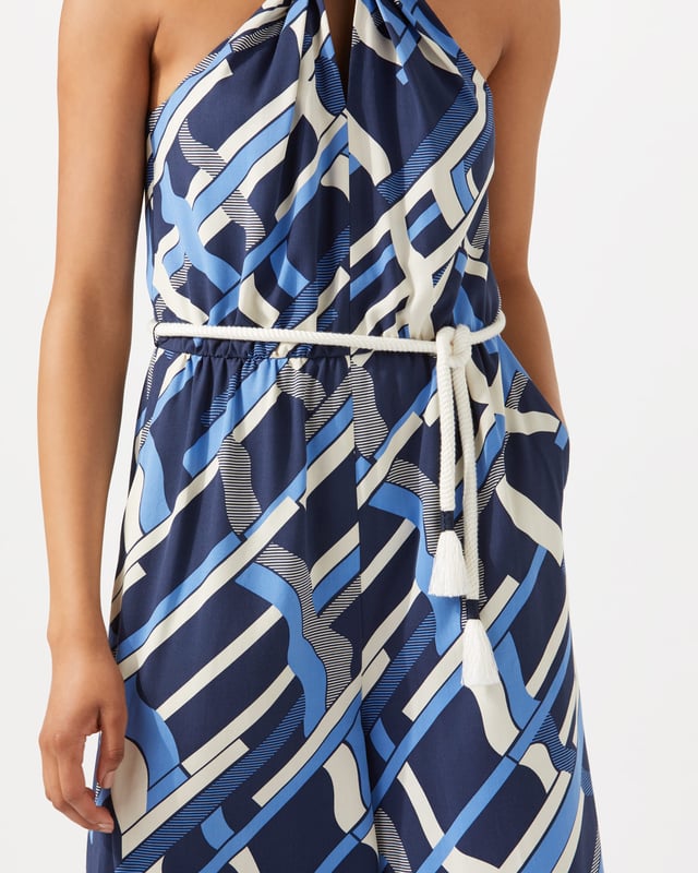 This jumpsuit features an exclusive modern Jigsaw print, hand-drawn by our in-house artist as a modern take on a check. Styled with a wide leg, it has a twist design at the neck and a rope tie at waist for a playful finish. Pair with heels for summer evenings out.