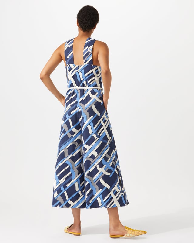 This jumpsuit features an exclusive modern Jigsaw print, hand-drawn by our in-house artist as a modern take on a check. Styled with a wide leg, it has a twist design at the neck and a rope tie at waist for a playful finish. Pair with heels for summer evenings out.