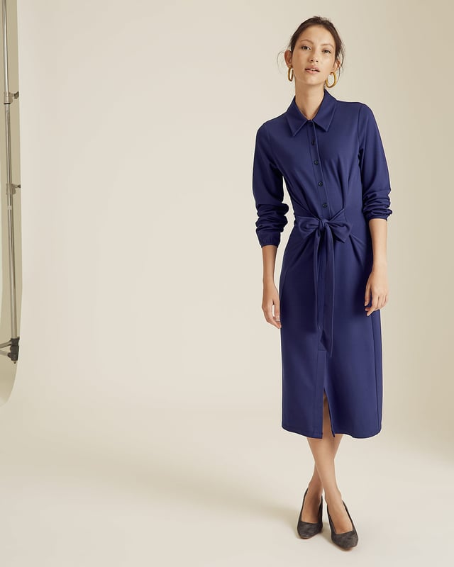 A new shape for Autumn Winter 19, this jersey dress has a shirt style upper and a fluid skirt. Designed with long sleeves, it has a front tie detail on the hips to create a feminine silhouette. Dress it up with our Daphine knee high boots or wear casually with leather trainers.