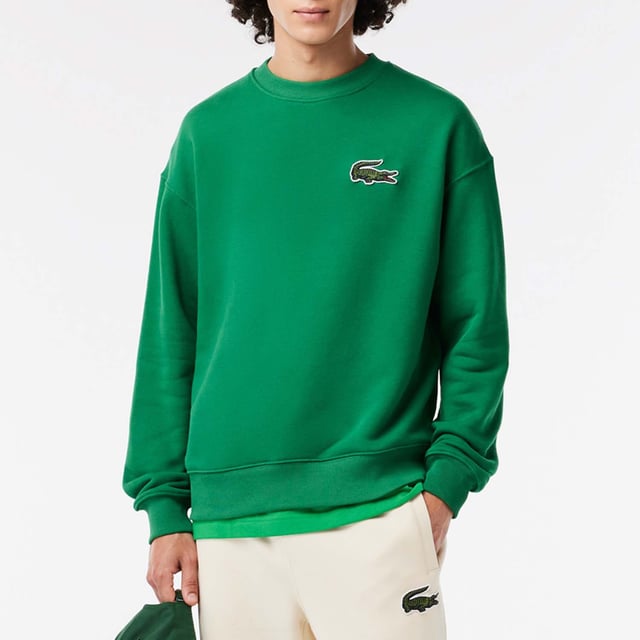 Unisex Lacoste Loose Fit Crocodile Badge Jogger Sweatshirt.- Loose fit, large cut, lowed shoulders.- Fleece crew neck.- Large crocodile on chest.- Embroidered crocodile sewn onto nape of the neck.- Organic unbrushed cotton fleece.
