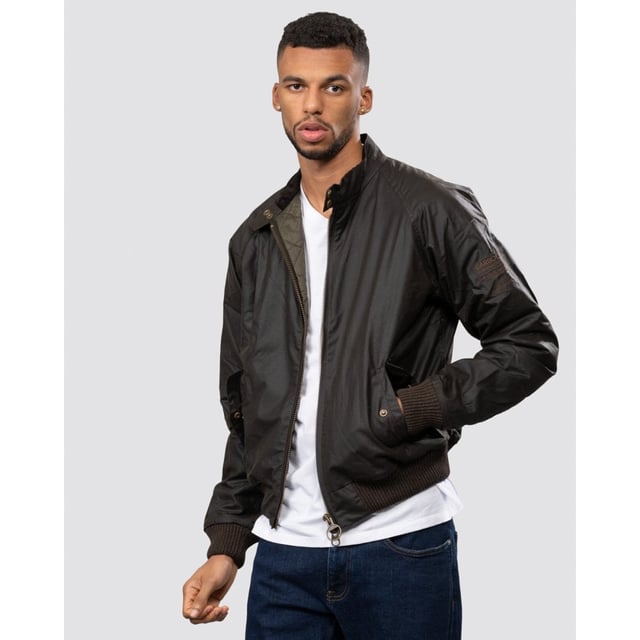 From the Steve McQueen™ International collection, the Merchant jacket is a bomber-style waxed jacket made with a tough waxed cotton outer, inspired by the jackets worn by the American actor and racer.
Durable enough for everyday, the Merchant is a simple, robust jacket that's medium weight with a quilted nylon lining for extra warmth. A corduroy-lined funnel neck with stud close gives the classic International look. Ribbed fabric on the sleeves and waist allow extra wind protection and stud-close angled pockets keep hands free.

Tailored Fit
99% Cotton, 1% Elastane
Denim, rinse wash
Barbour International denim branding pack with waist rider, leather patch, hang loop and tear off fit label.
Sponge clean only&nbsp;