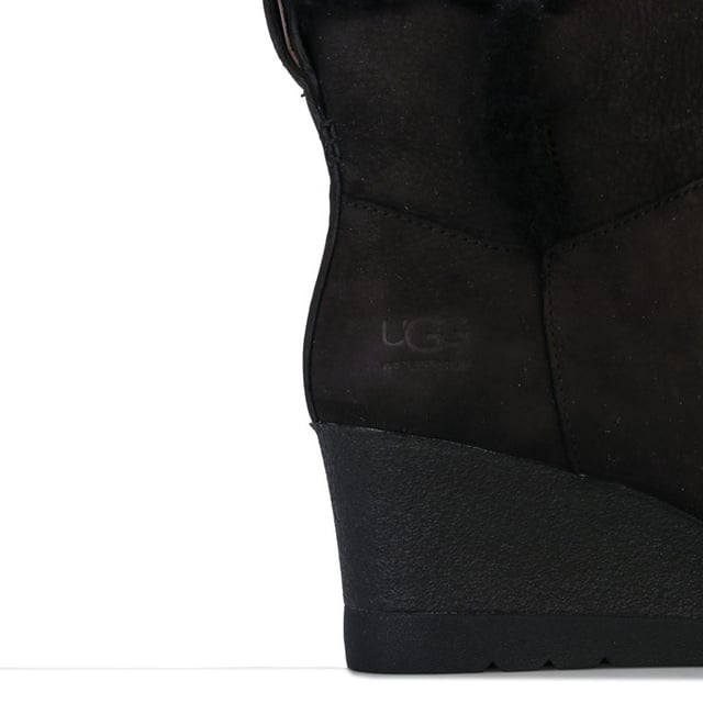 Womens UGG Australia Devorah Boots in black.<BR><BR>- Waterproof suede upper with seam-sealed construction.<BR>- Almond shaped toe.<BR>- Pull-on loop for easy on-off.<BR>- Soft sheepskin lining.<BR>- UGGpure wool insole.<BR>- Wedge heel.<BR>- Flexible White Spider Rubber outsole.<BR>- Debossed UGG branding to side.<BR>- Wedge height: 2.5in approximately.<BR>- Shaft height: 4.5in approximately.<BR>- Suede upper  Textile lining  Rubber sole.<BR>- Ref: 1103824<BR><BR>Measurements are intended for guidance only.<BR><BR>We sell genuine UGG® boots.  These are only available in half sizes.  Therefore if you were to order a size 5 we shall send you a 5.5 which we know from experience will be the best fit.
